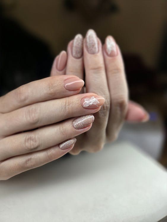 Elegant nude and glitter manicure close-up